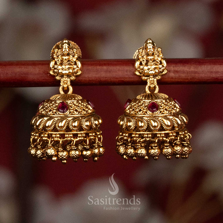 Traditional temple style matte gold ruby AD stone Lakshmi Devi jhumka earrings with sculpted stud motif and rich layered bead detailing, high quality jewellery for saree wear- Sasitrends