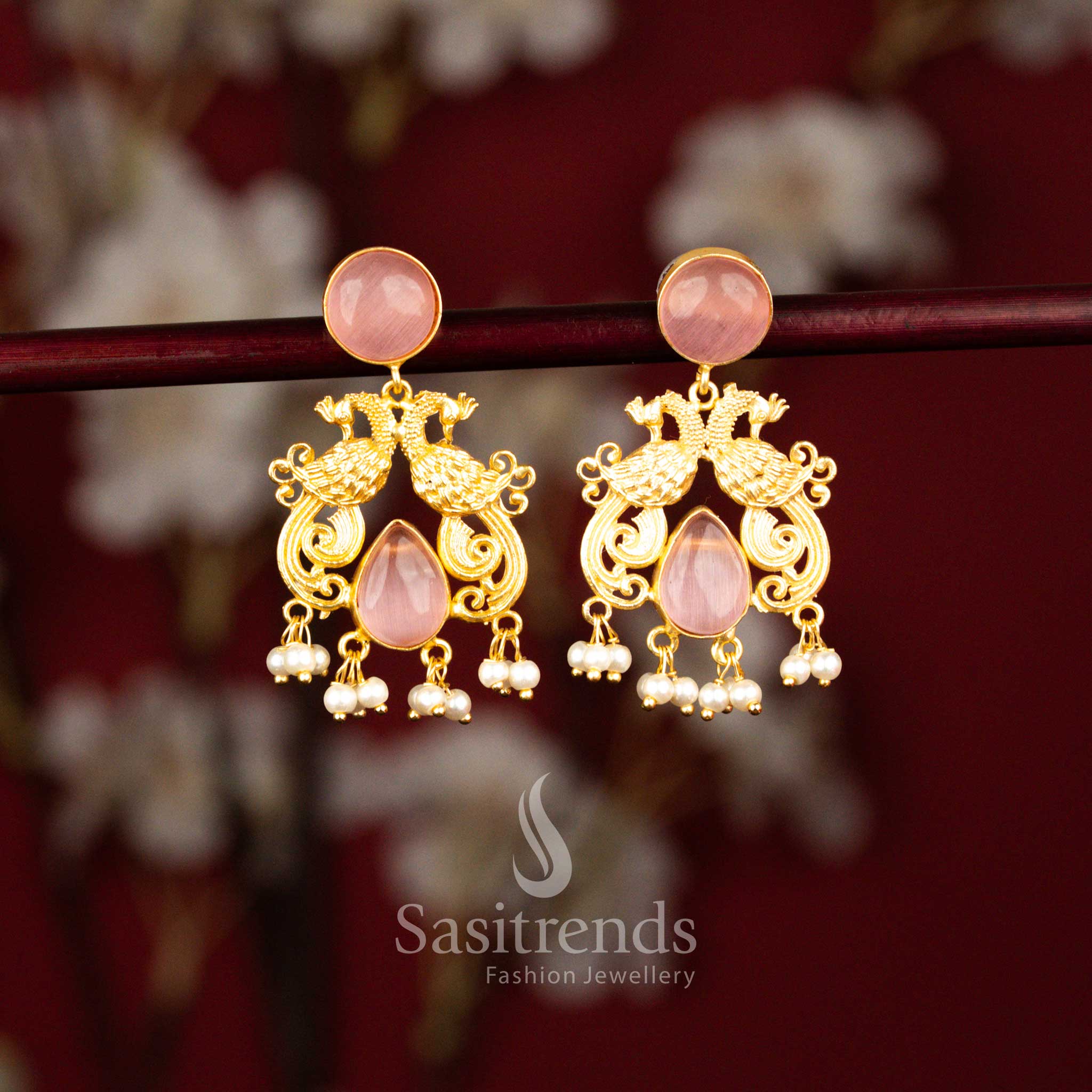 Elegant 24K gold plated dual peacock circular teardrop stone earrings enhanced with pearls in soft pink shade for festive wear – Sasitrends
