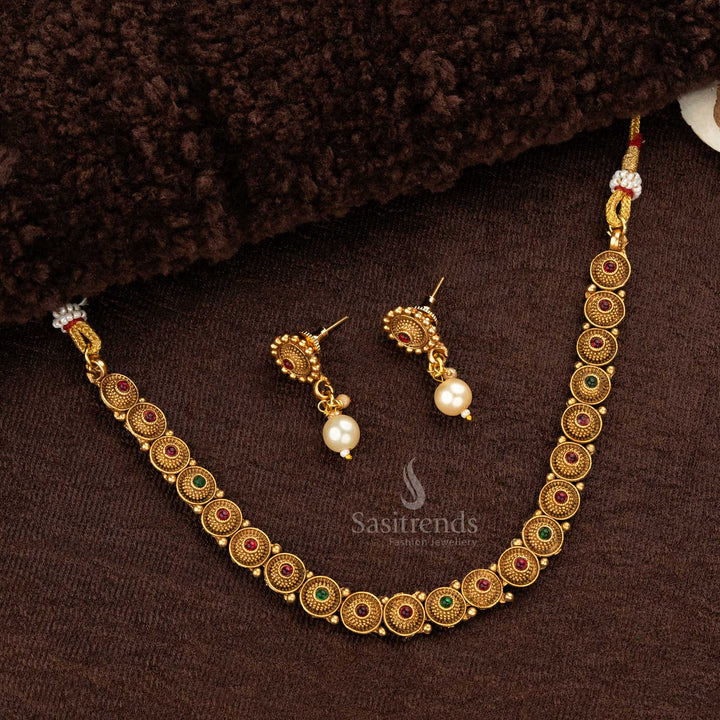 Floral pendant-style matte gold temple necklace set featuring ruby and green stones, completed with matching drop earrings - Sasitrends
