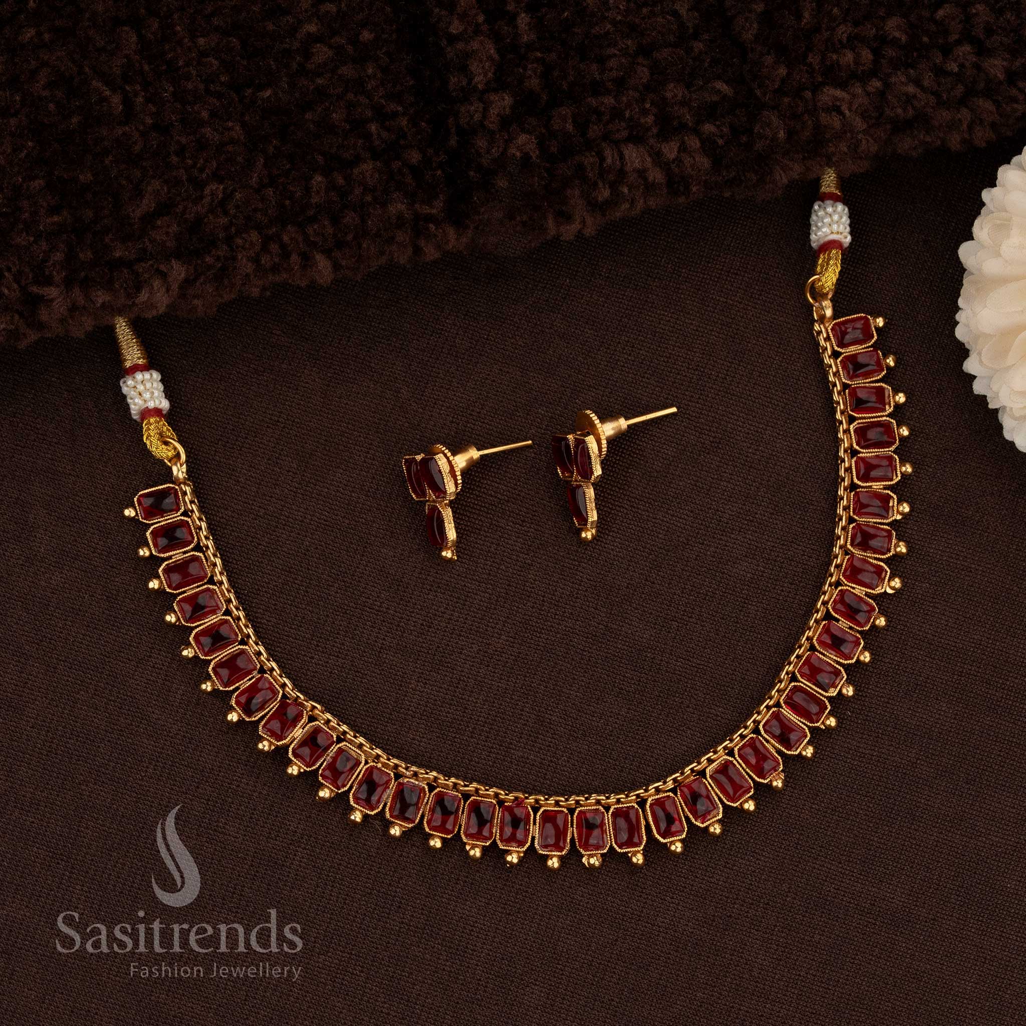 Gorgeous Classic Matte Gold Necklace Jewellery Set Adorned With Rectangular Kemp Stones In Ruby Colour, Featuring Matte Gold Plating, Artistic Detailing, And A Grand Finish Ideal For Bridal And Party Wear Styling – Sasitrends
