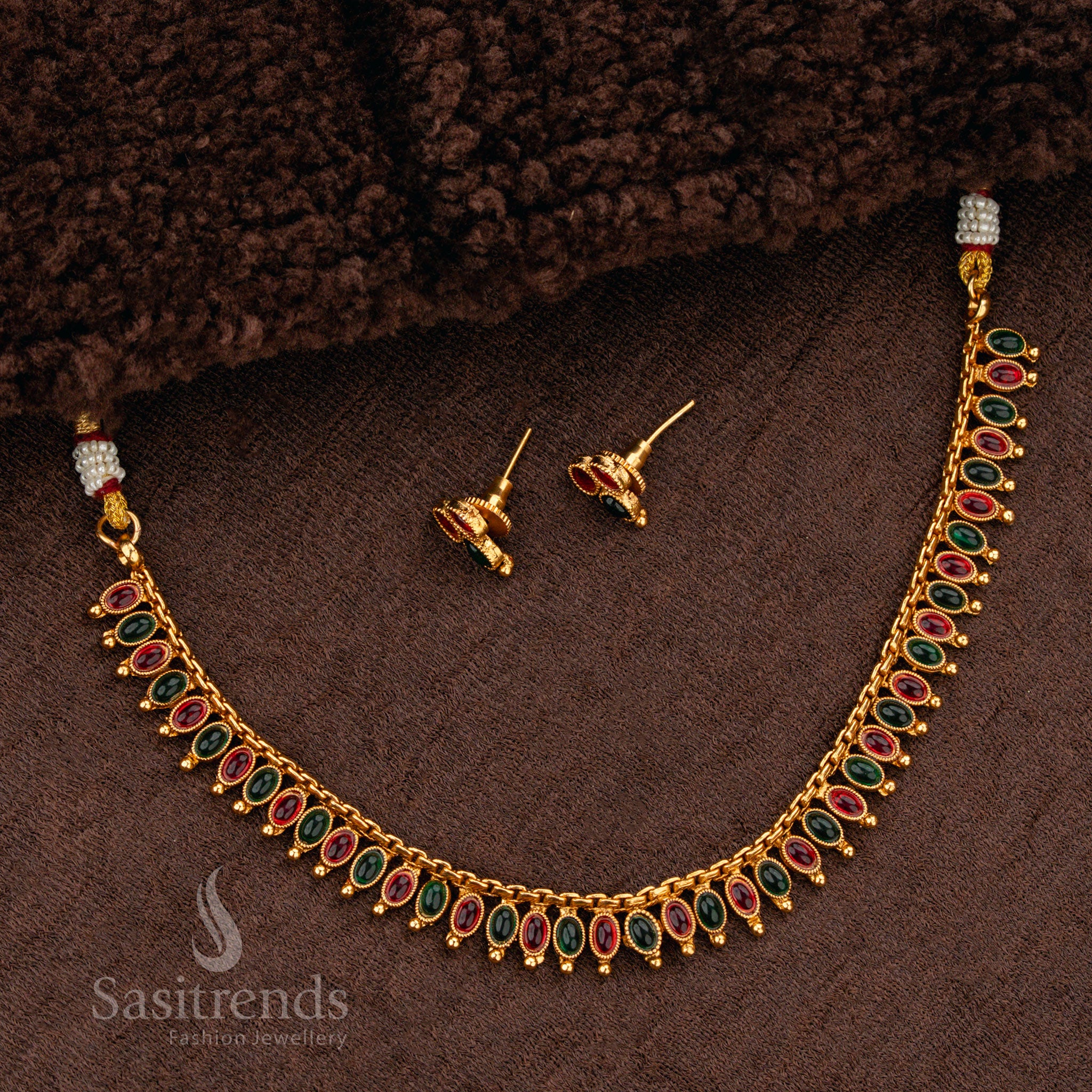 Luxurious ruby-green stone matte gold plated necklace set, featuring an ornate handcrafted finish, making it a regal choice for bridal jewellery - Sasitrends