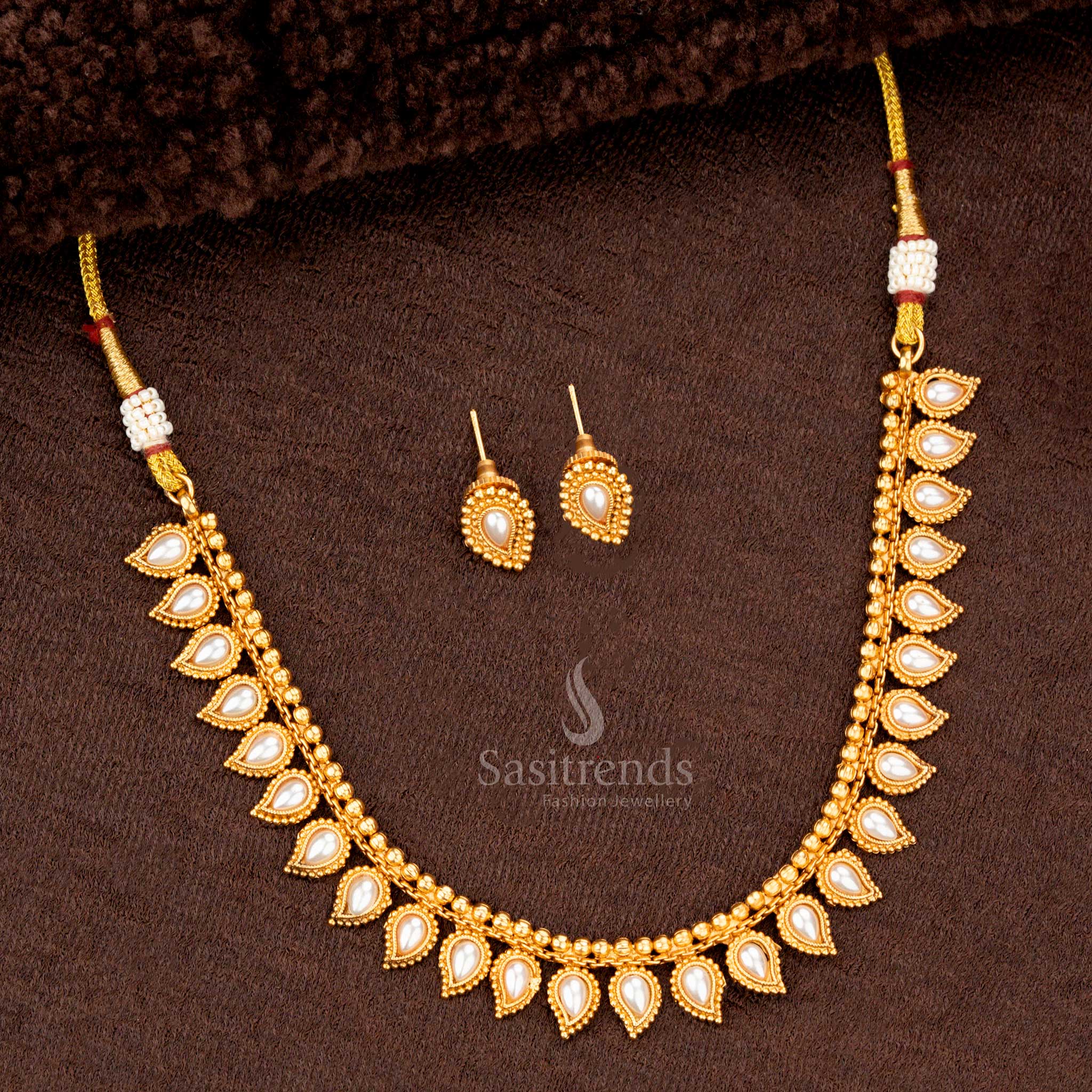 Traditional necklace set with pearl teardrop motifs and matching earrings, perfect for weddings and festive occasions - Sasitrends