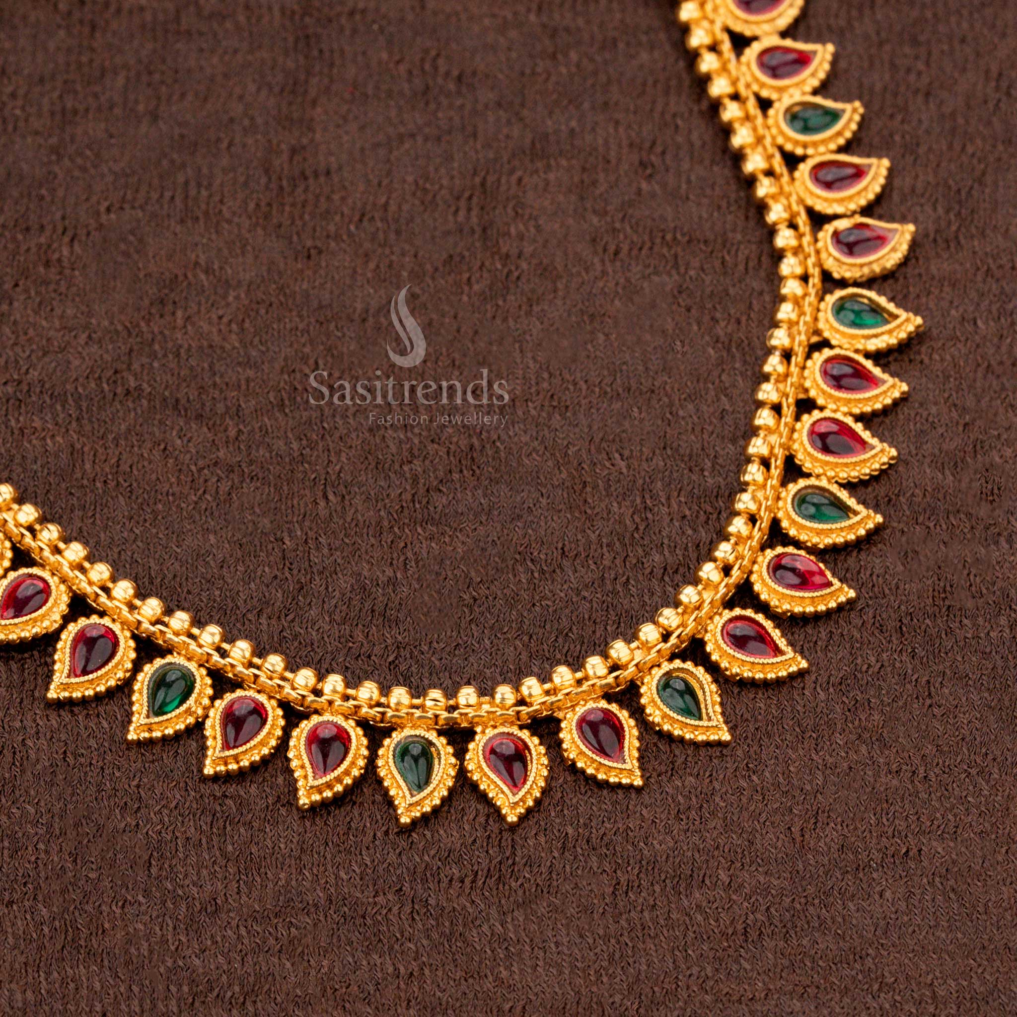 Traditional ruby and green teardrop motif necklace with earrings, perfect for weddings and ethnic wear - Sasitrends