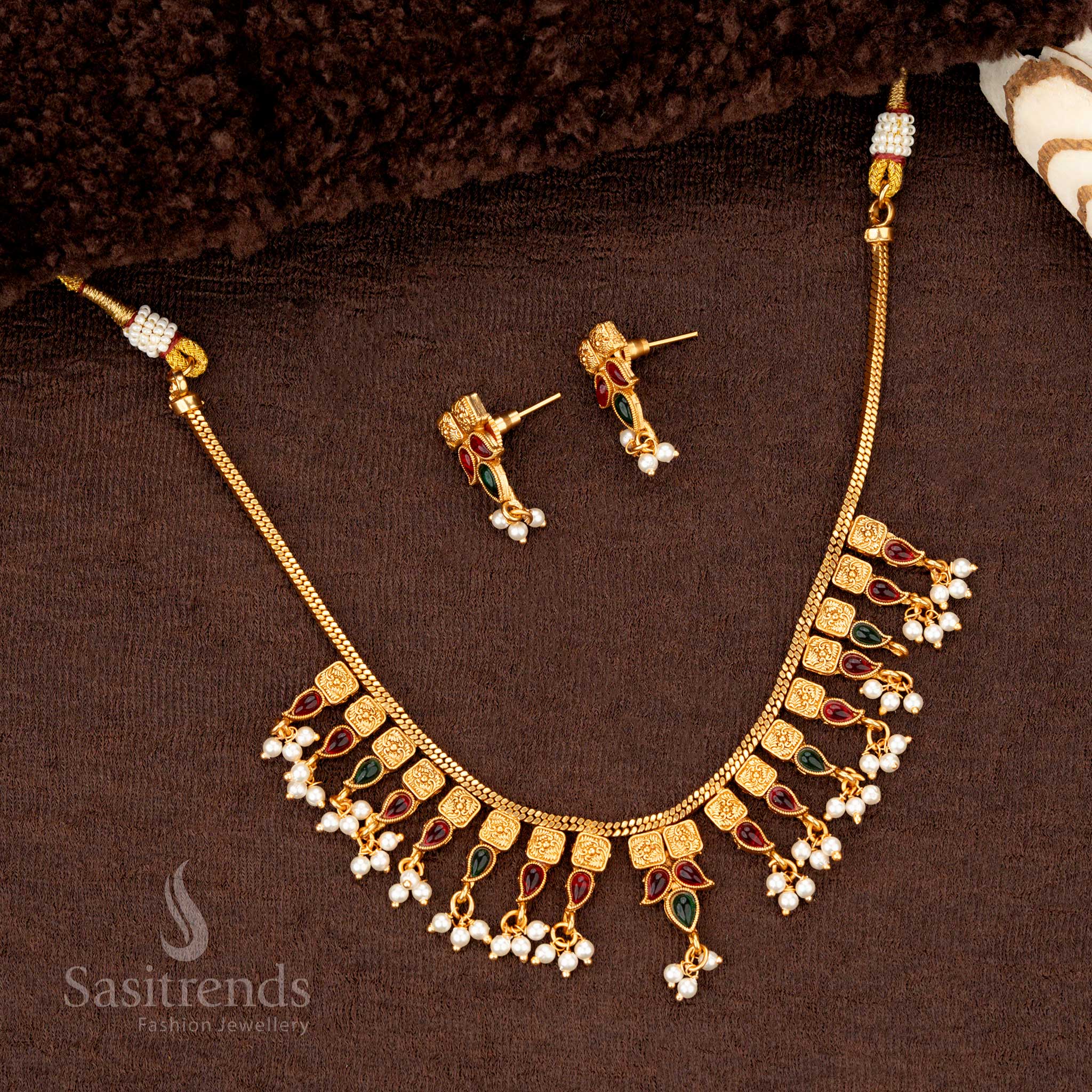 Ruby-green temple jewellery with pearl drops, square motifs, and gold beadwork - Sasitrends