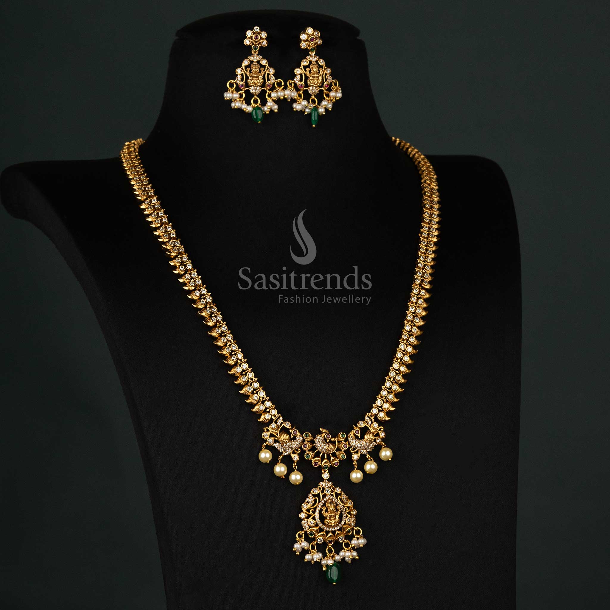 Artistic temple jewellery set with a peacock motif, ruby-green AD stones, green beads, and matte gold plating - Sasitrends