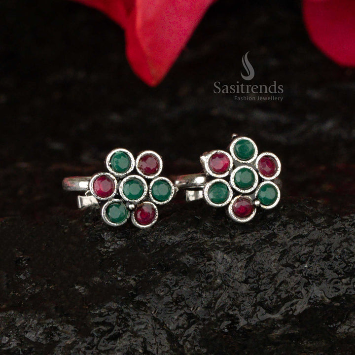 Oxidised floral toe ring with a bold ruby centerpiece and green leaf details, showcasing an antique royal charm - Sasitrends