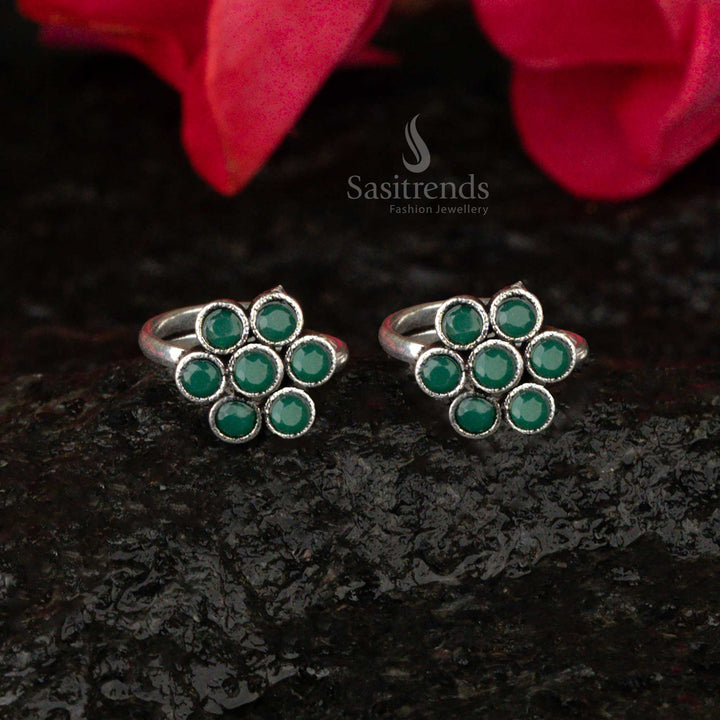 Oxidised adjustable flower toe ring with a forest green gem, showcasing a delicate antique finish - Sasitrends