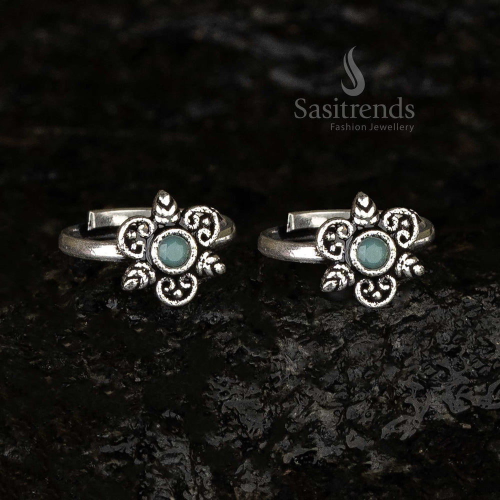 Oxidised round toe ring featuring a mint green stone as its centerpiece, surrounded by swirl and leaf patterns for a soothing vintage-inspired look - Sasitrends
