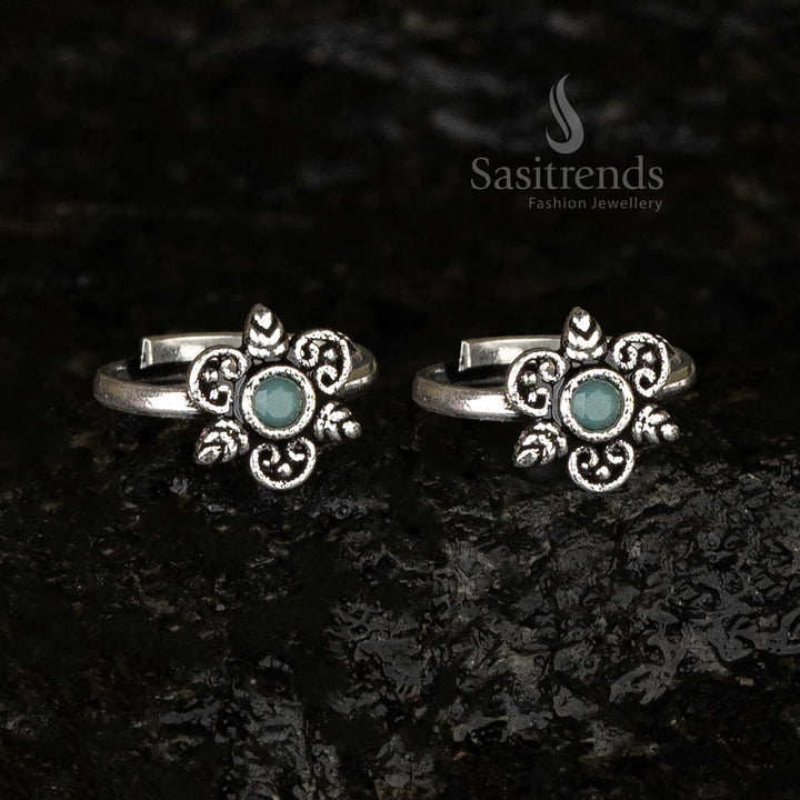 Oxidised round toe ring featuring a mint green stone as its centerpiece, surrounded by swirl and leaf patterns for a soothing vintage-inspired look - Sasitrends