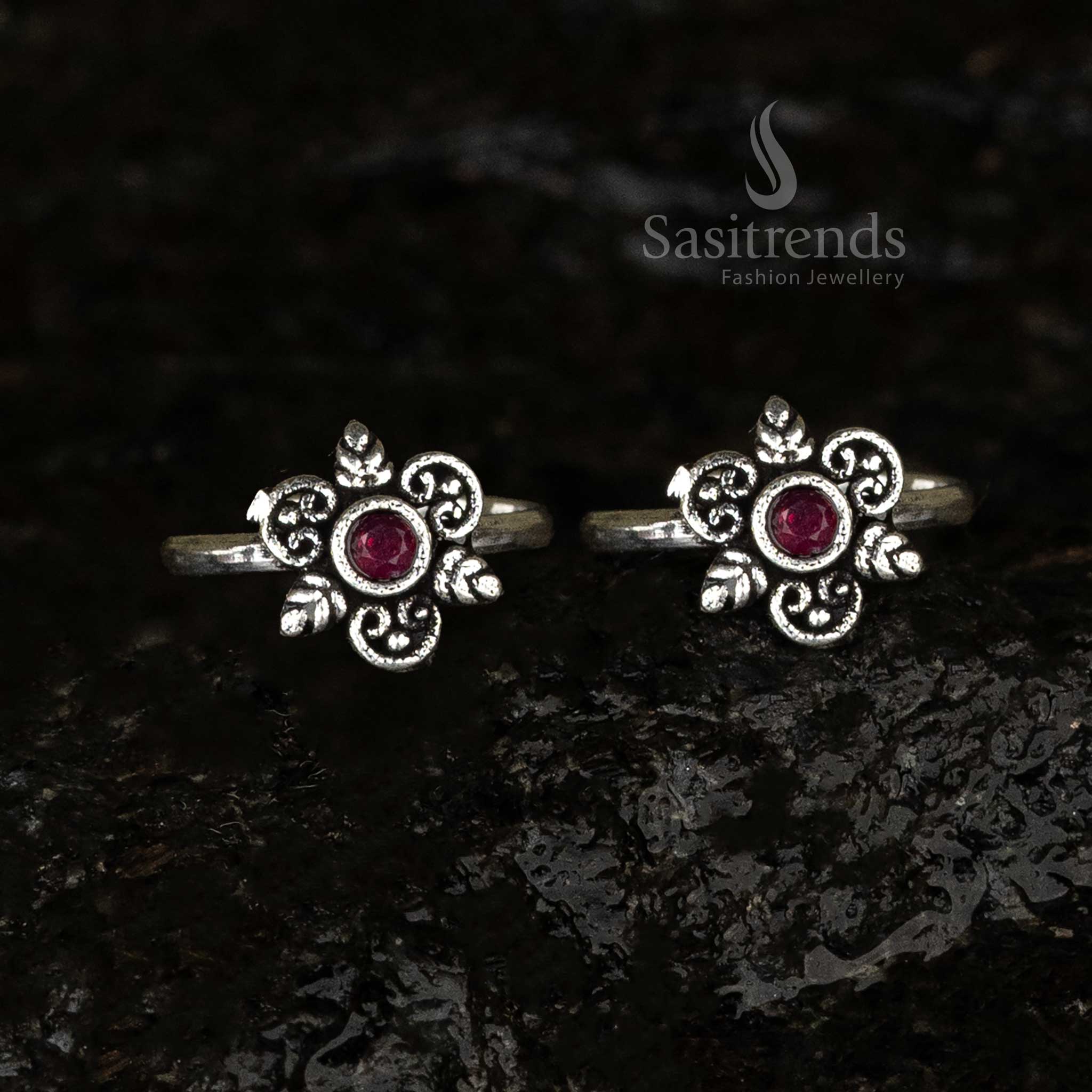 Oxidised round toe ring with a radiant ruby centerpiece and swirl and leaf motif, offering a crimson antique charm - Sasitrends
