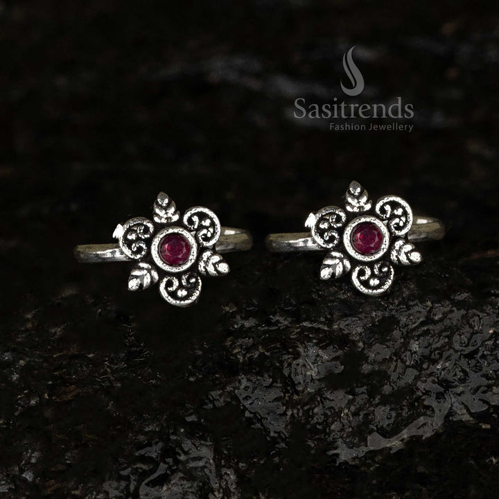 Oxidised round toe ring with a radiant ruby centerpiece and swirl and leaf motif, offering a crimson antique charm - Sasitrends
