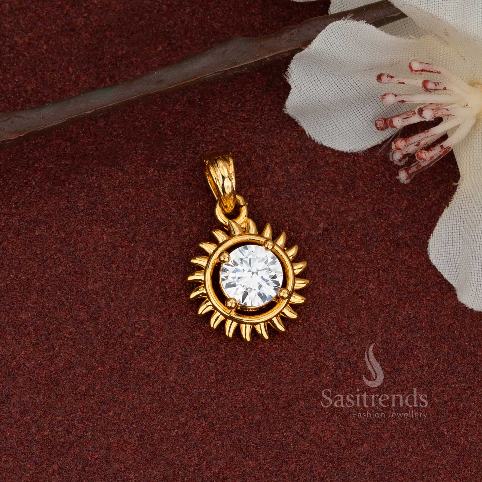 A single sun-shaped AD stone pendant, micro gold plated to look like real gold, highlighting its radiating rays and elegant product structure.