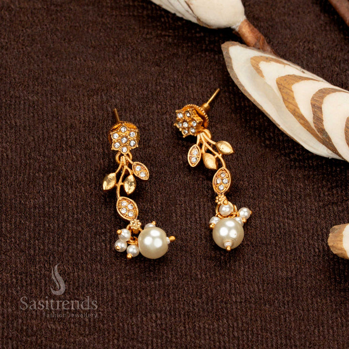 Luxurious matte gold temple jewellery with asymmetric vine detailing and pearl accents - Sasitrends