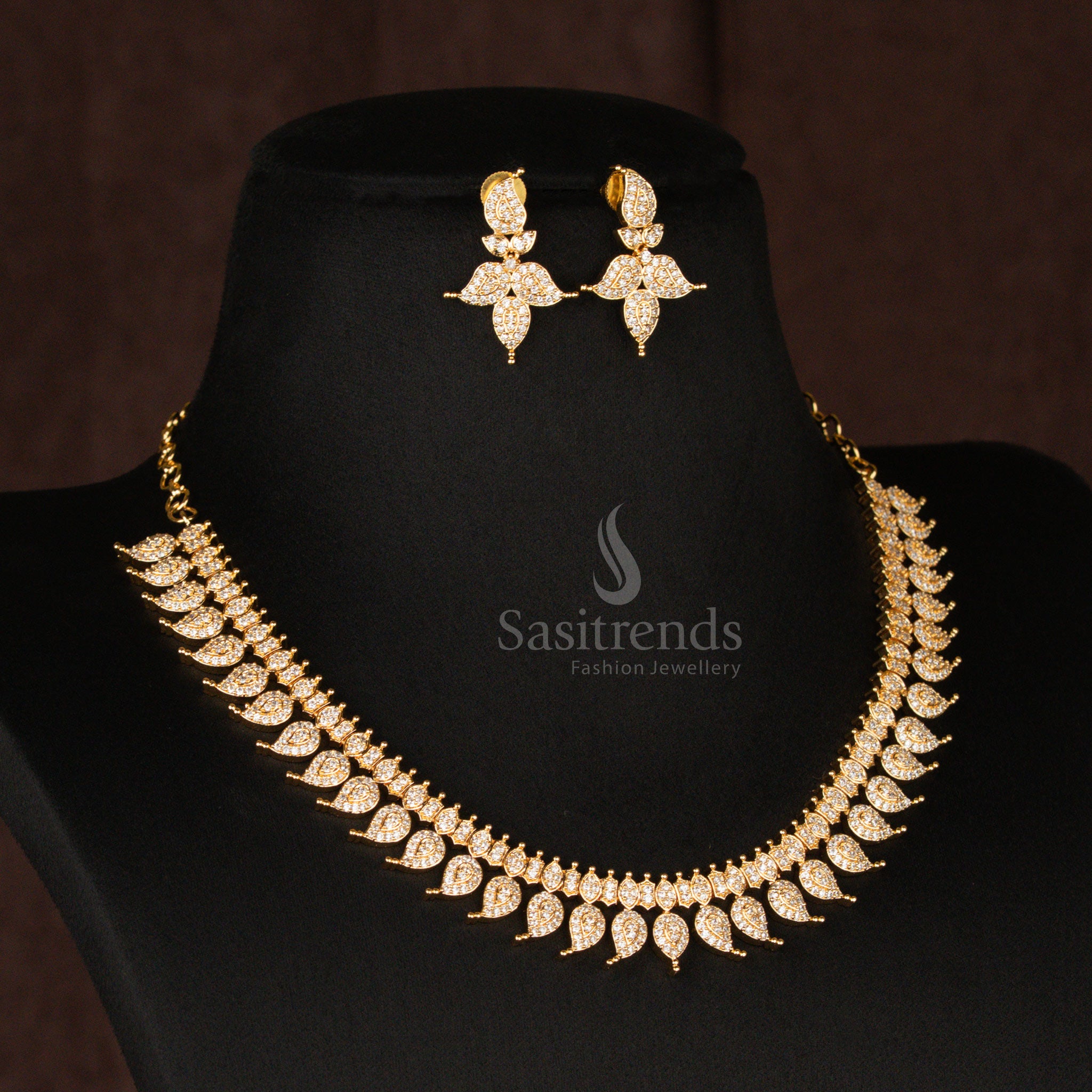 Classic pearl-white American Diamond gold plated mango leaf short haram necklace set, exuding a timeless appeal, perfect for elegant traditional jewellery lovers