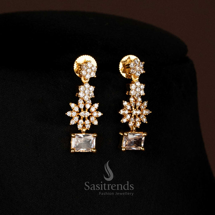 Close-up of dazzling American Diamond micro gold plated drop earrings, featuring starburst clusters and rectangular accent stones, SKU 2572I - Sasitrends