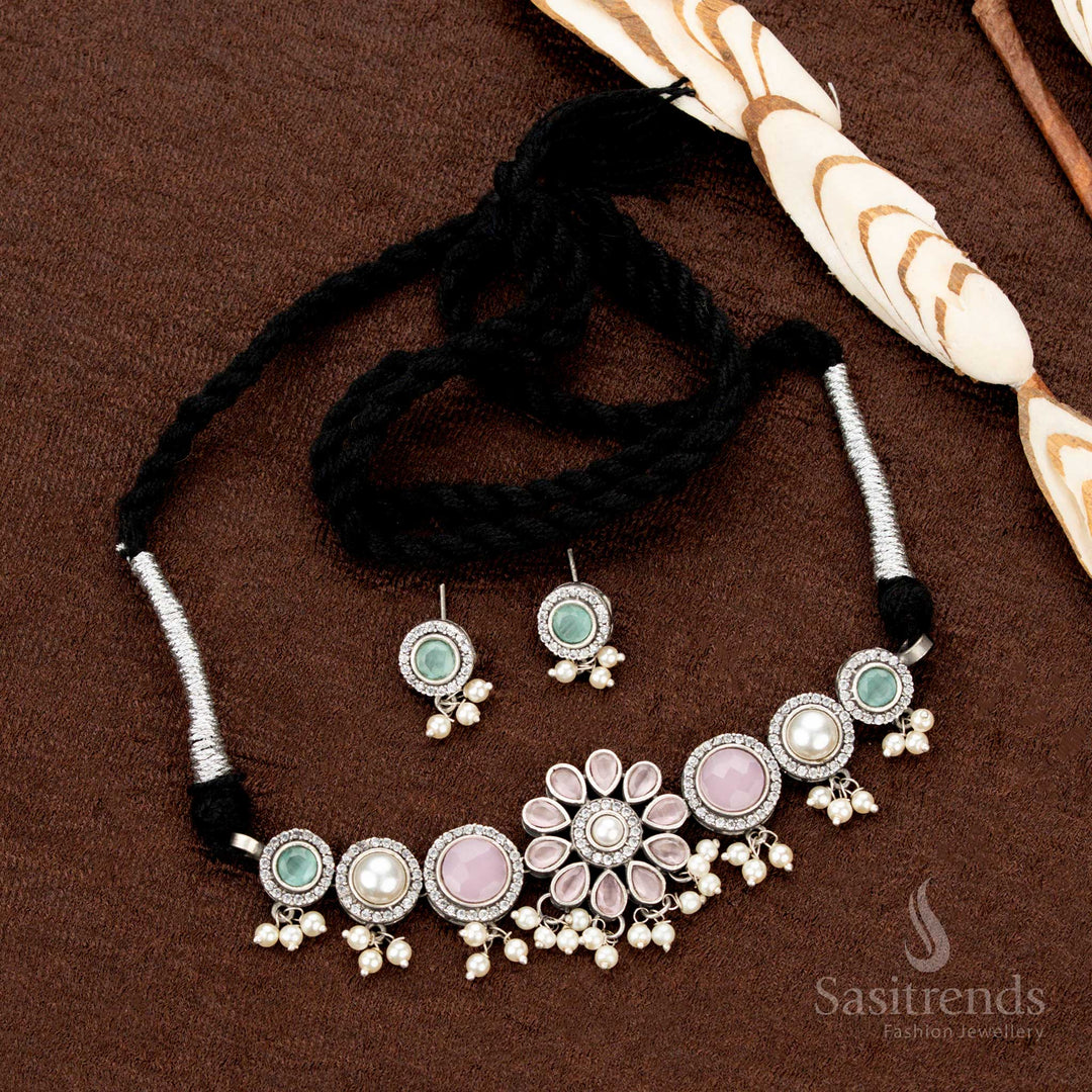 Fusion-style oxidised statement choker with floral multistone charms and pearl hangings, an eclectic jewellery pick for traditional and Navaratri flair - Sasitrends