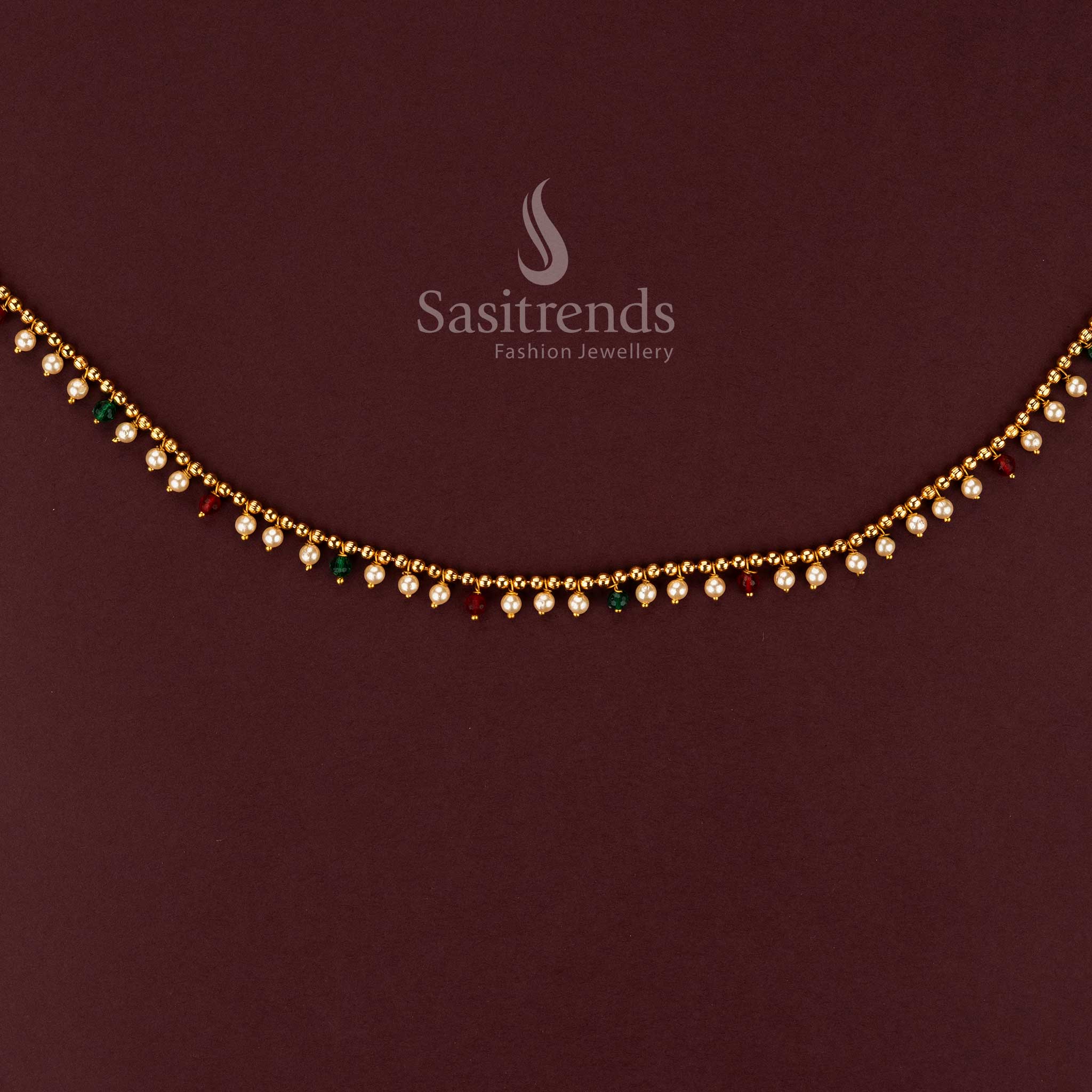 Close-up of elegant single line hip belt featuring small pearls and colorful bead accents 