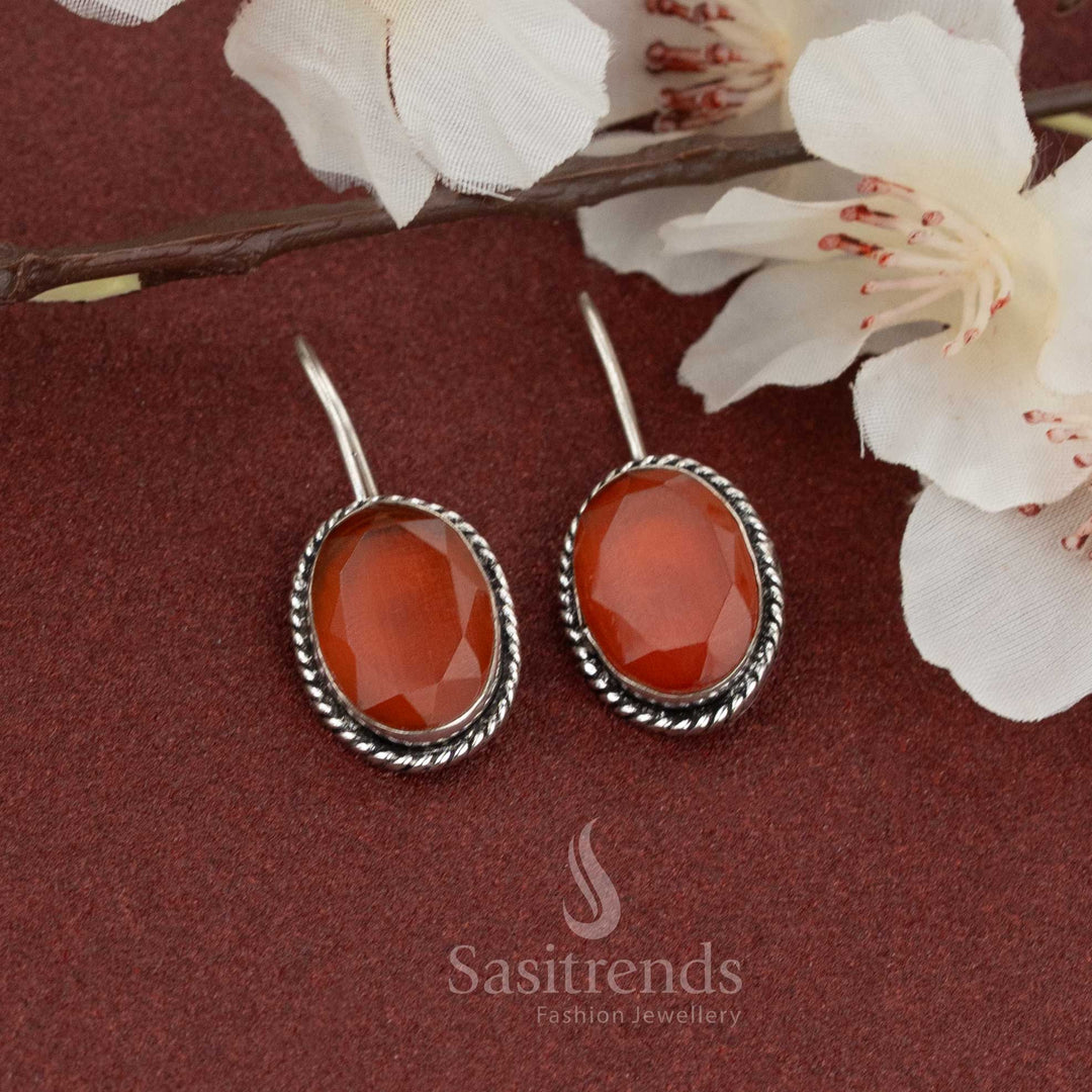 Bold casual wear oxidised earrings with oval orange natural stone and twisted rope border – fish hook style perfect for daily and festive looks – Sasitrends
