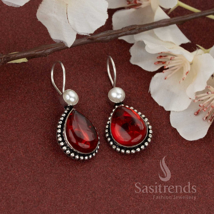 Bold red teardrop stone oxidised earrings with elegant pearl top – for a confident statement look – Sasitrends