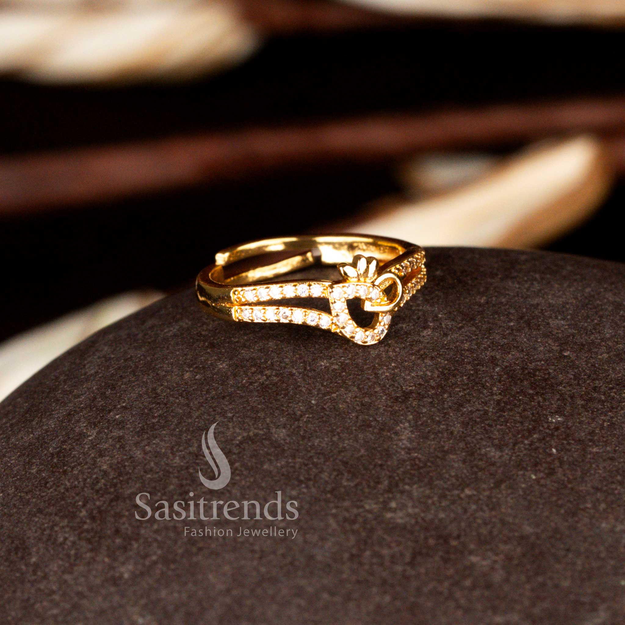 Sasitrends traditional one gram micro gold plated adjustable white crystal-lined heart silhouette topped with a polished three-petal crown motif whiote AD ring featuring premium stone setting and a luxury gold finish suitable for weddings and festive gatherings.