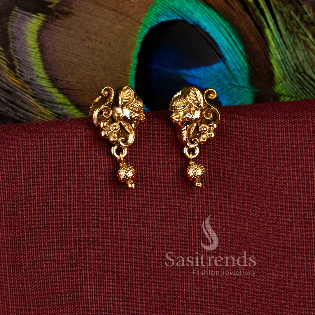 Traditional matte gold plated Lord Ganesha temple stud earrings with hanging textured gold ball droplets by Sasitrends.