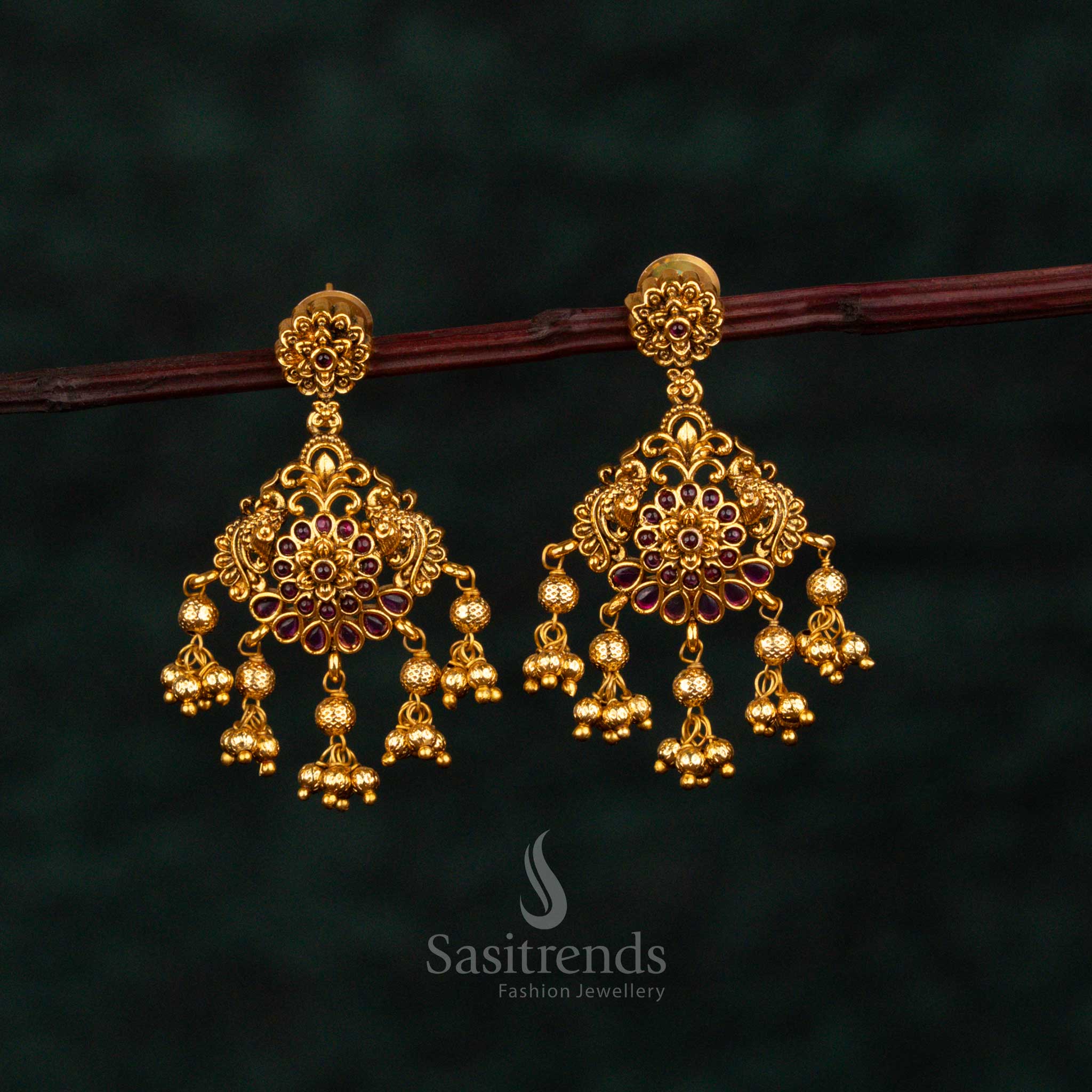 Splendid ruby layered drop earrings adorned with floral AD brilliance, eternal matte gold finish, baroque artistry, and enchanting bridal jewellery heritage – Sasitrends