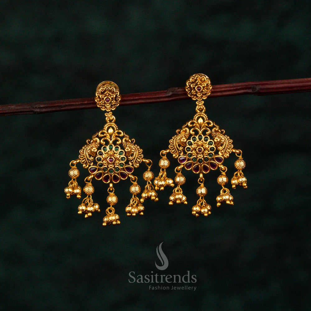 Grandiose ruby green teardrop earrings with layered floral AD embellishments, radiant matte gold artistry, noble craftsmanship, and celestial wedding grandeur – Sasitrends