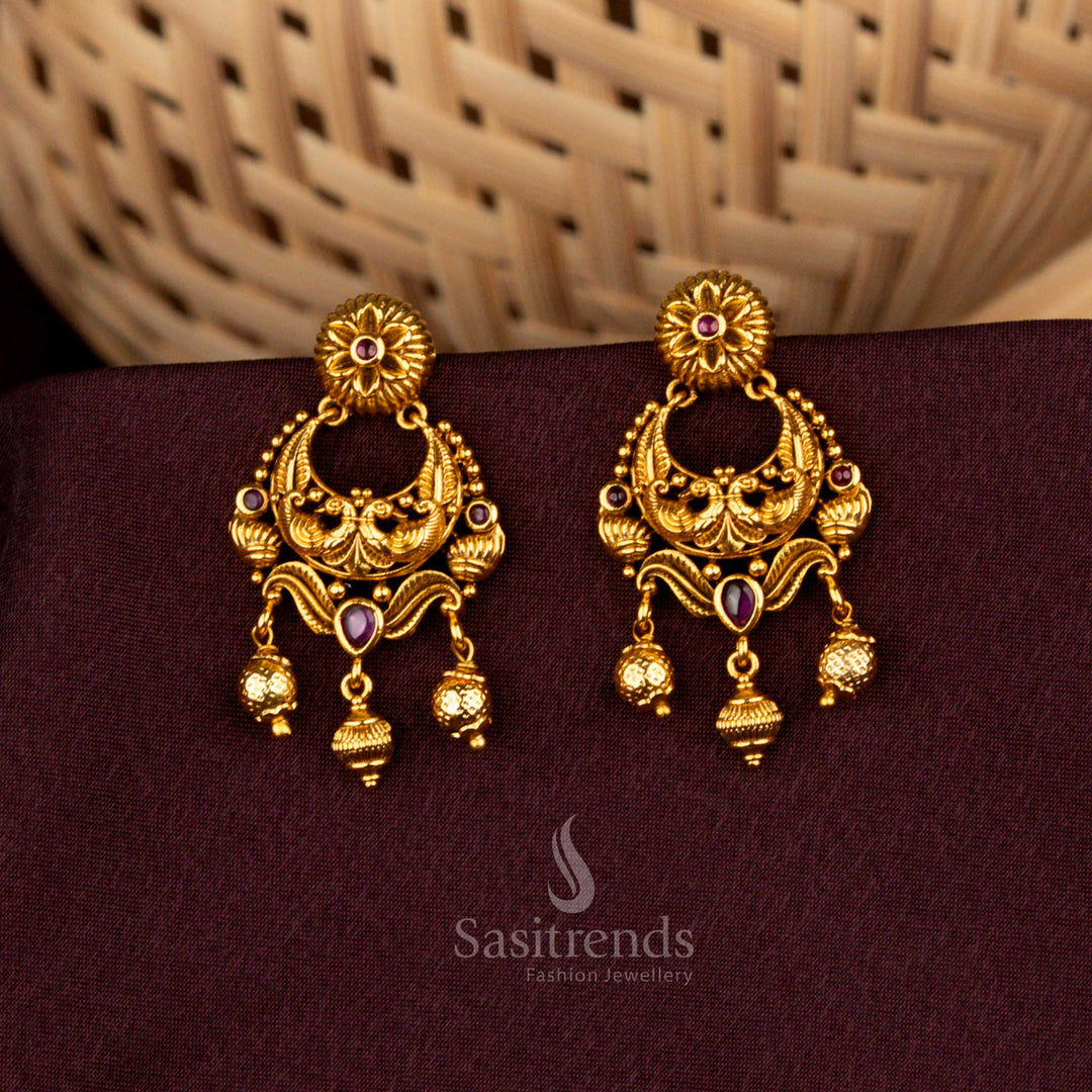 Regal ruby temple earrings with peacock detailing, floral carvings, matte gold finish, radiant AD brilliance, and aristocratic charm crafted for weddings – Sasitrends