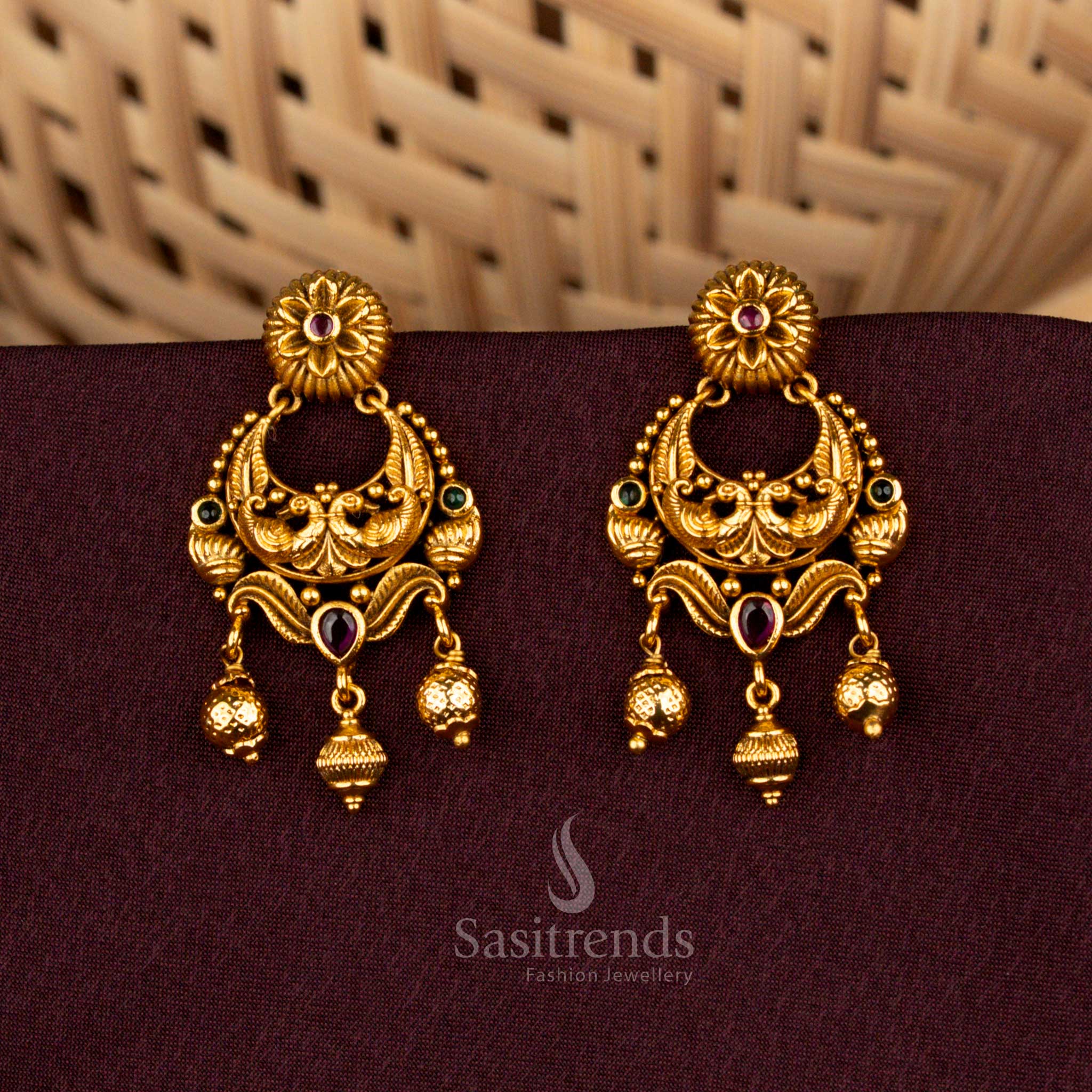Majestic ruby green temple earrings showcasing divine peacock artistry, floral AD brilliance, matte gold elegance, and noble refinement created for splendid bridal celebrations – Sasitrends