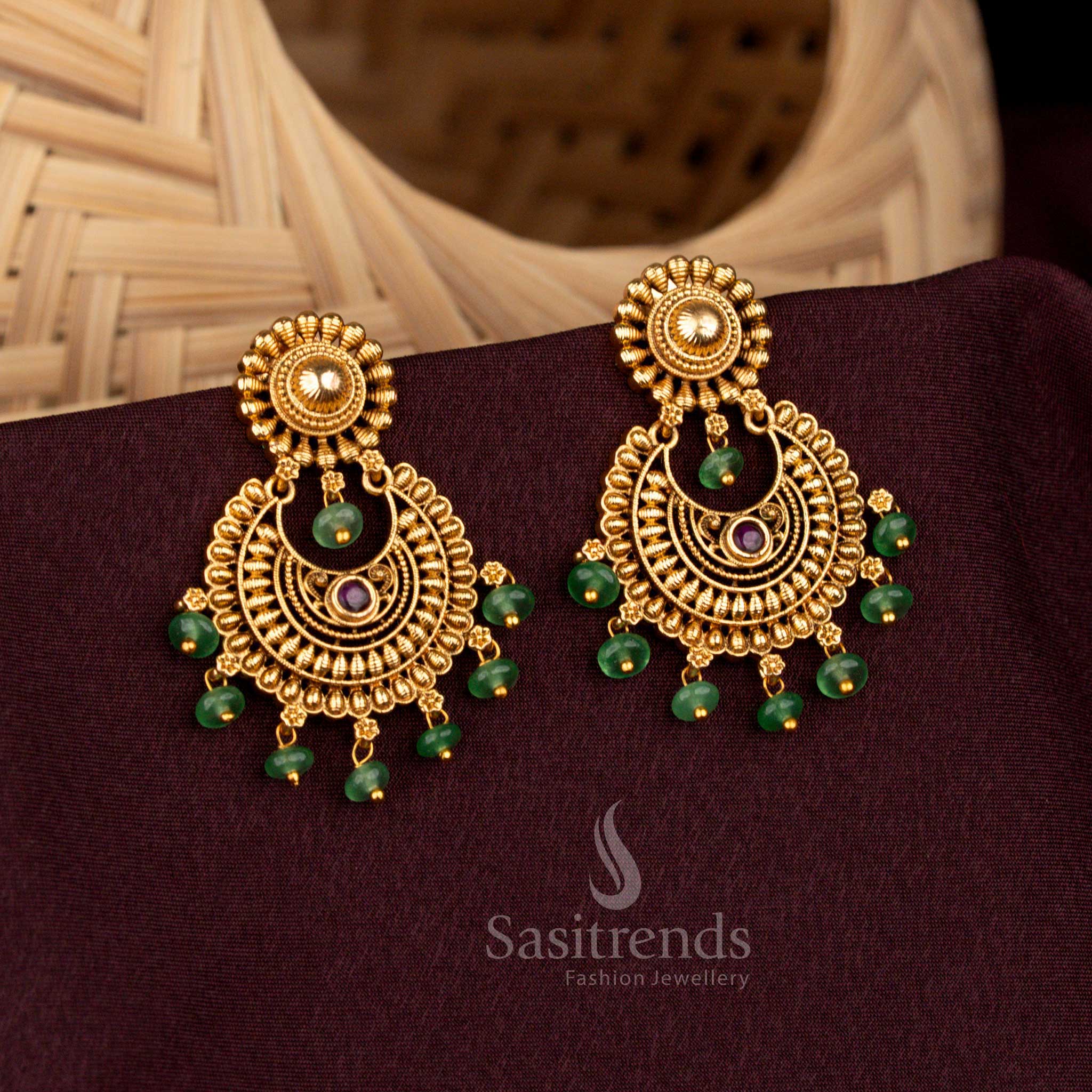 Regal ruby circular floral temple earrings crafted with ornate crescent motif, resplendent matte gold artistry, aristocratic heritage refinement, and bridal splendour – Sasitrends