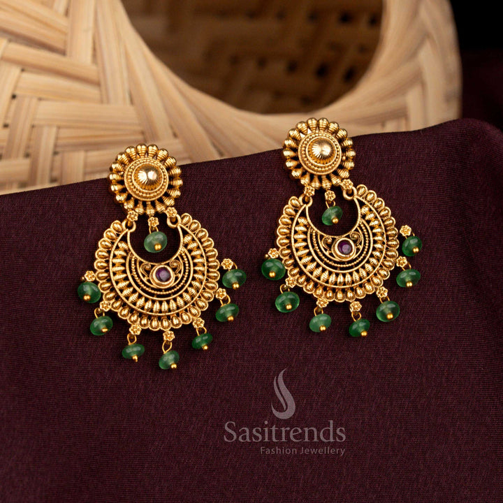 Regal ruby circular floral temple earrings crafted with ornate crescent motif, resplendent matte gold artistry, aristocratic heritage refinement, and bridal splendour – Sasitrends