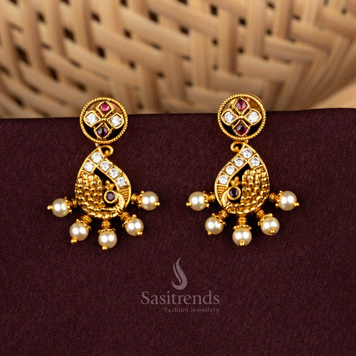 Graceful Matte Gold Plated Stud Earrings with Paisley Peacock With AD Accents and Pearl Drops
