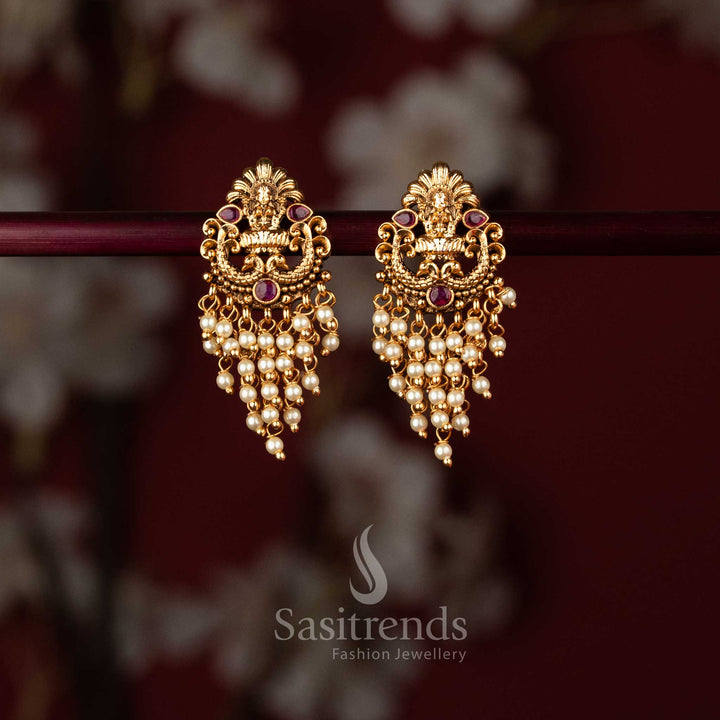 Elegant matte gold plated temple earrings showcasing Lakshmi and peacock artistry embellished with ruby stones pearl – Sasitrends