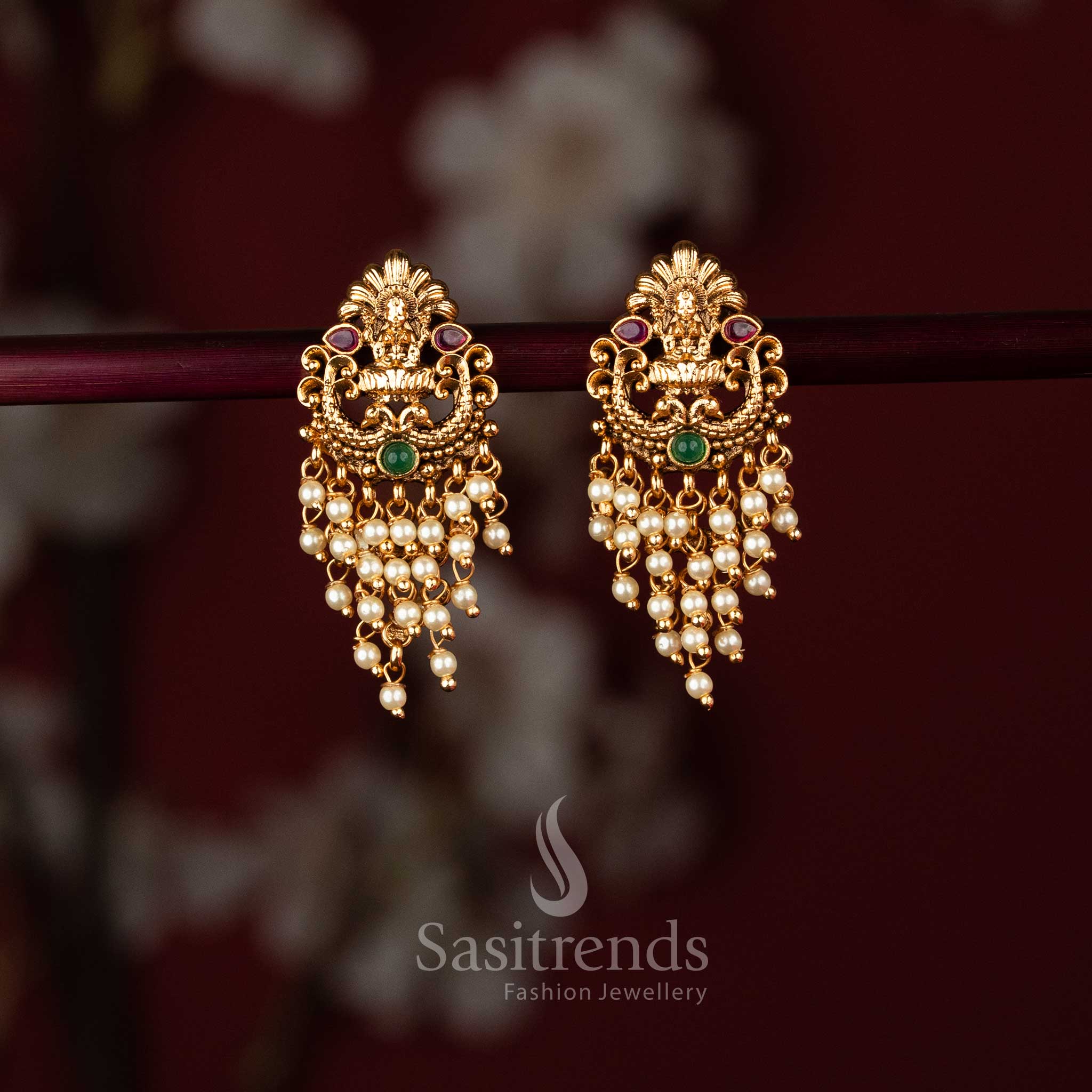 Elegant matte gold plated temple earrings showcasing Lakshmi and peacock artistry embellished with ruby green stones pearl – Sasitrends