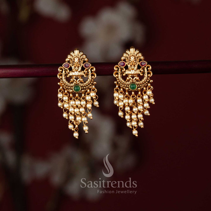 Elegant matte gold plated temple earrings showcasing Lakshmi and peacock artistry embellished with ruby green stones pearl – Sasitrends