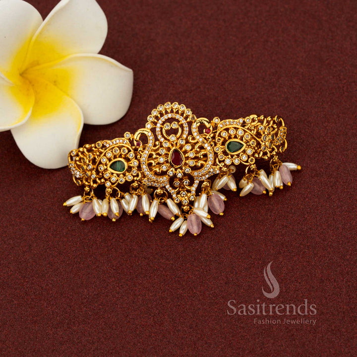 Seraphic pink matte gold hair clip enriched with teardrop floral detailing, luminous AD stones, ornate temple craftsmanship, and pearl highlights – Sasitrends