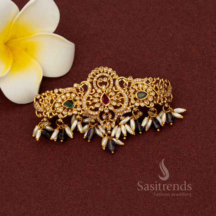 Glorious purple temple hair clip adorned with elegant matte gold finish, ornate teardrop floral motifs, radiant AD stones, and pearl accents – Sasitrends