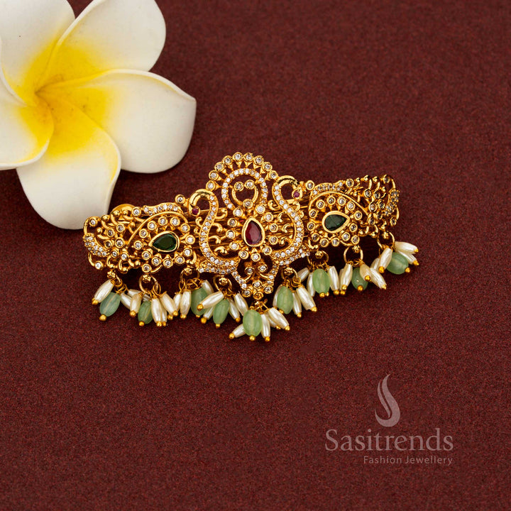 Enchanting mint matte gold hair clip with temple-inspired teardrop floral artistry, AD stone highlights, and graceful rice pearl danglers – Sasitrends