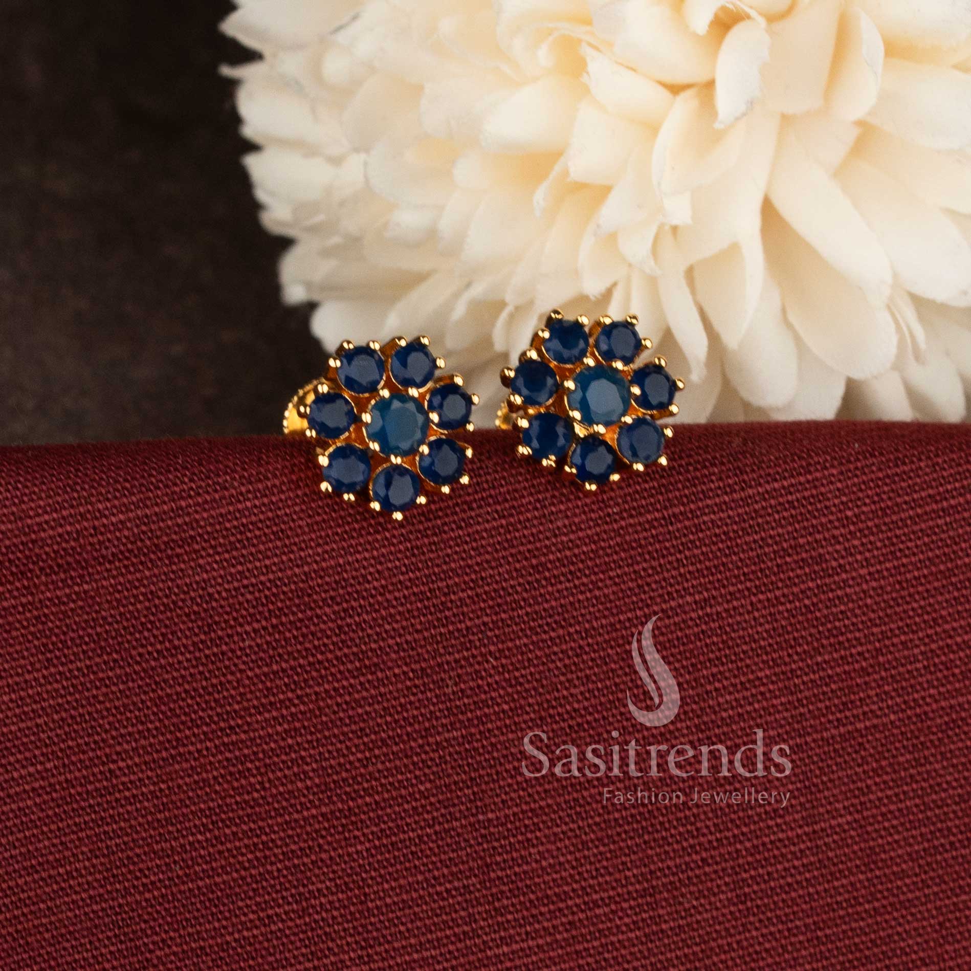 Stylish micro gold plated floral stud earrings with sparkling Blue AD stones.