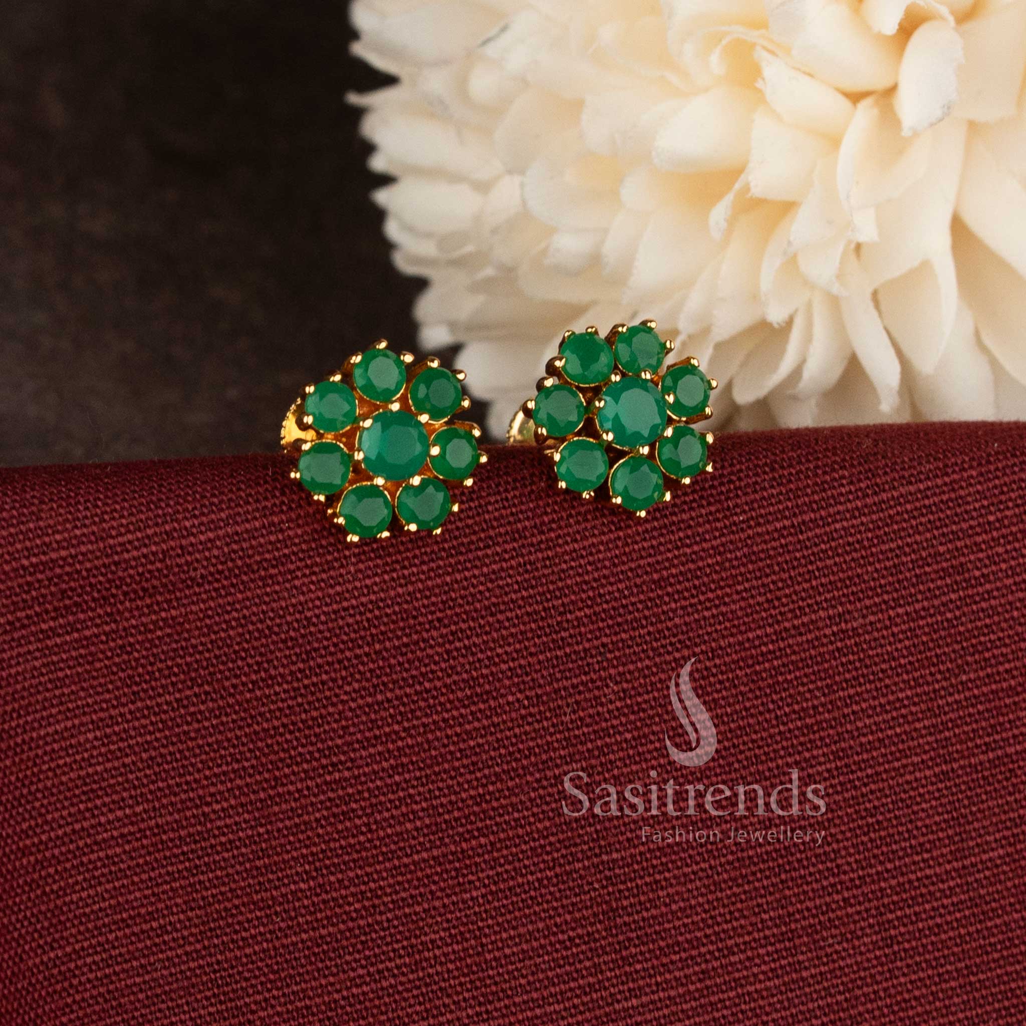Stylish micro gold plated floral stud earrings with sparkling green AD stones.