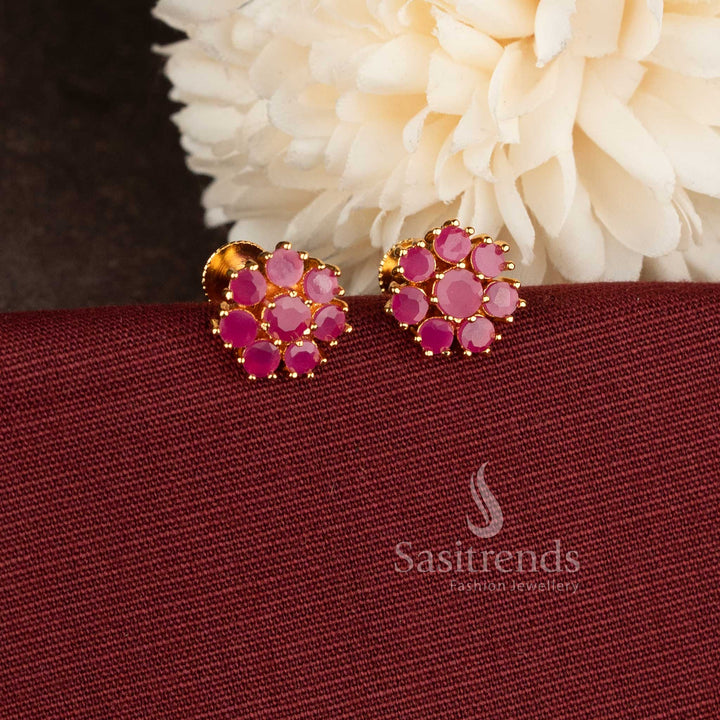 Trendy gold plated Ruby American Diamond stud earrings with floral pattern.