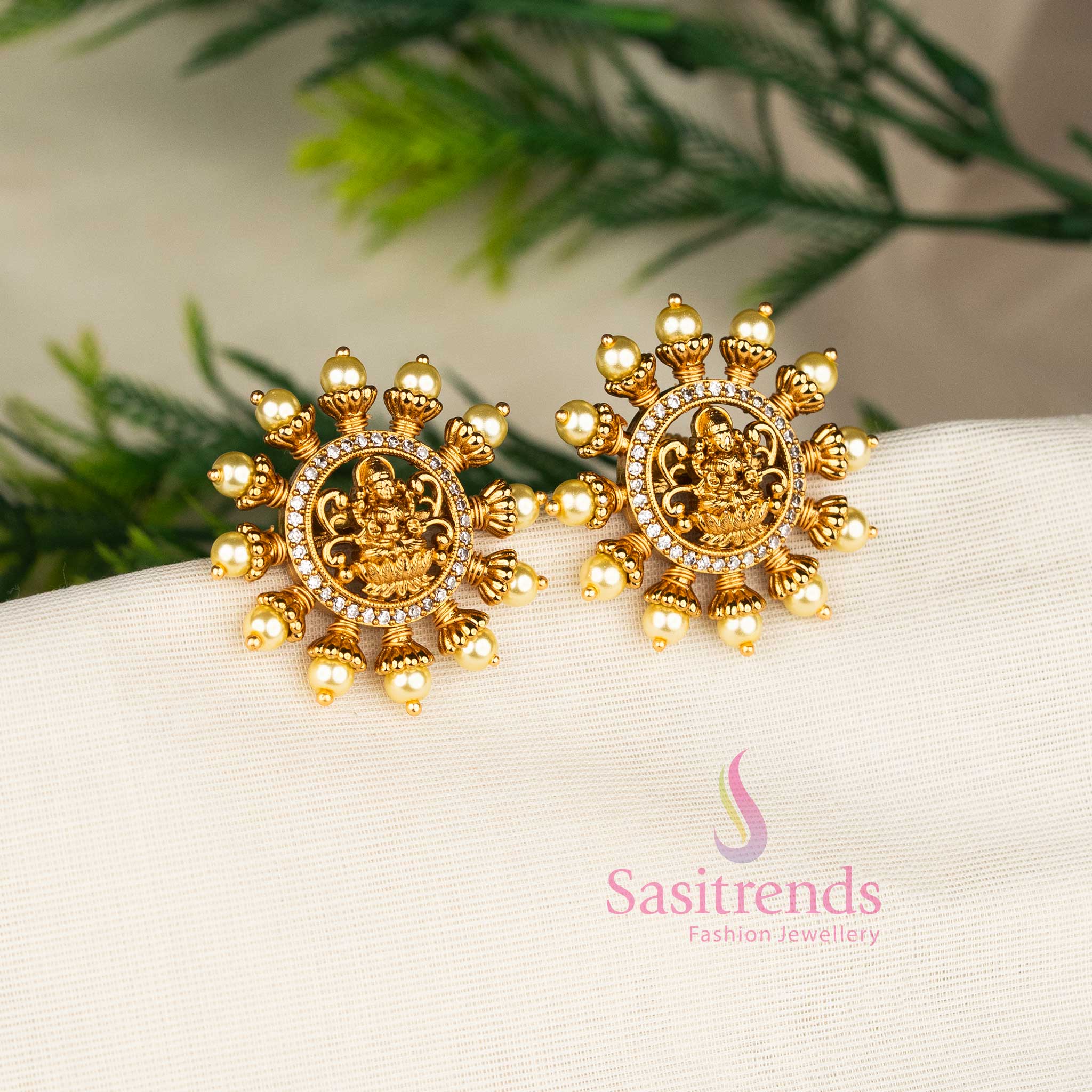 White matte gold plated Lakshmi motif pearl stud earrings, perfect for temple festivities and ethnic bridal ensembles – Sasitrends