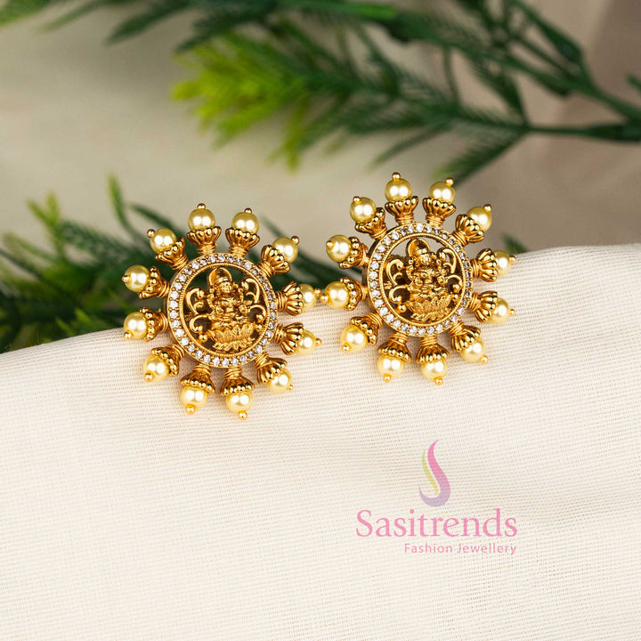 White matte gold plated Lakshmi motif pearl stud earrings, perfect for temple festivities and ethnic bridal ensembles – Sasitrends