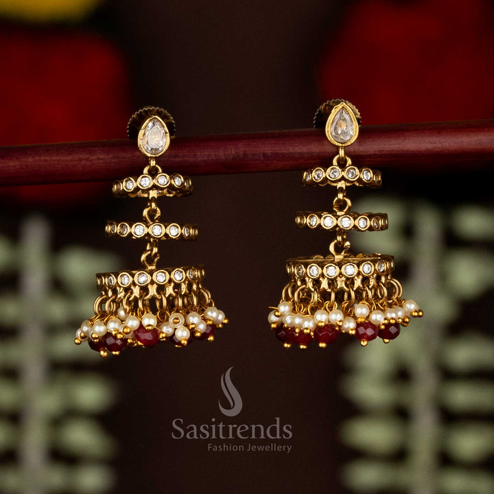 Temple Matte Gold Plated AD Stone Three-Tiered Jhumka Earrings with Teardrop Stud
