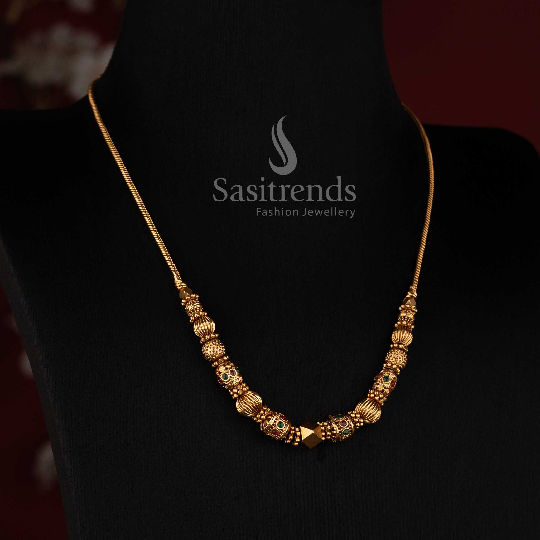 2760 traditional matte gold plated necklace with sculpted temple motifs centre ball and ornamental bead detailing by Sasitrends