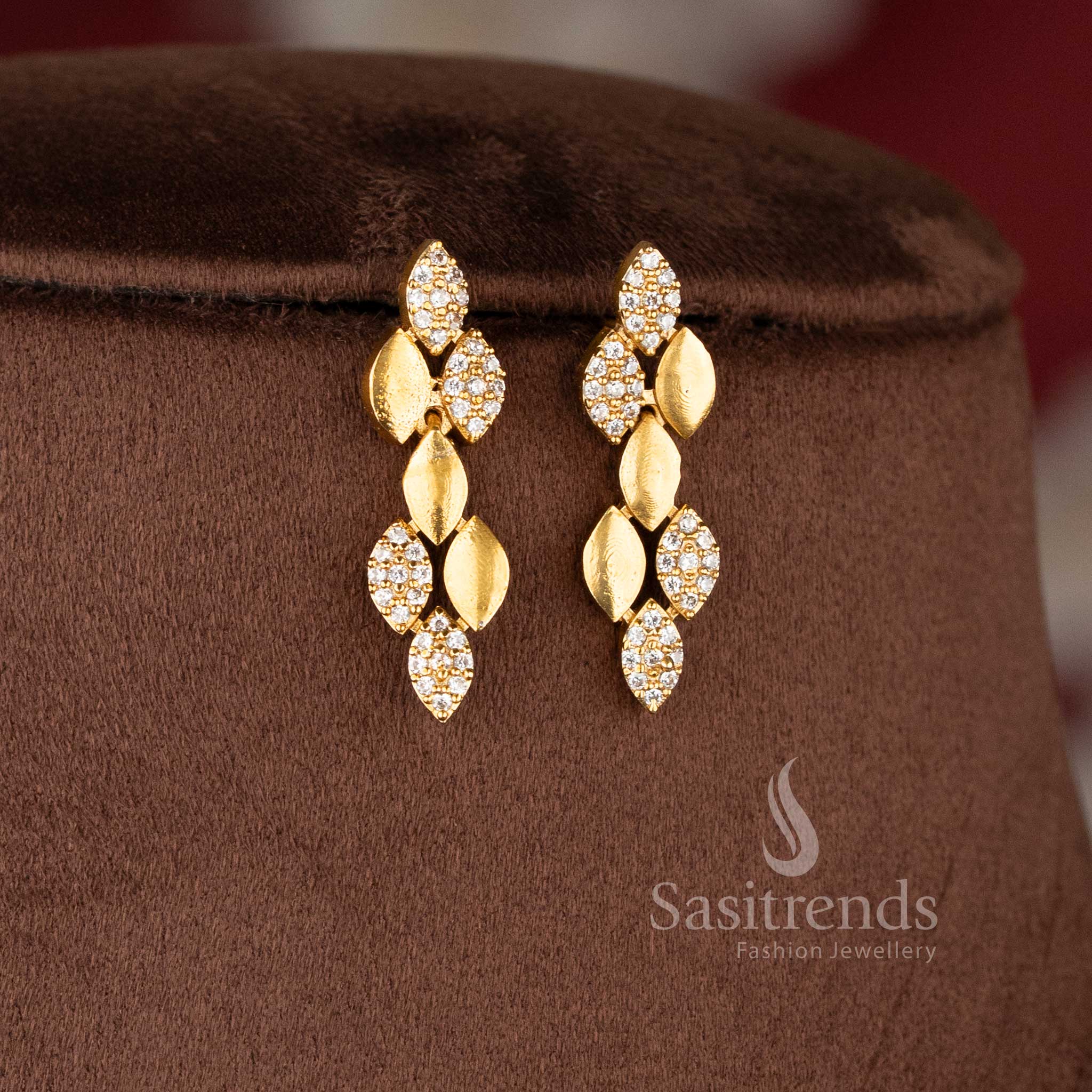 Matching linear leaf-drop earrings in a premium matte gold finish, ideal for modern temple jewellery for wedding styling - Sasitrends