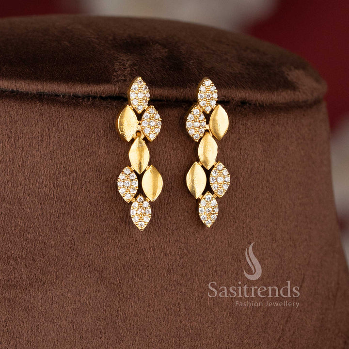 Matching linear leaf-drop earrings in a premium matte gold finish, ideal for modern temple jewellery for wedding styling - Sasitrends