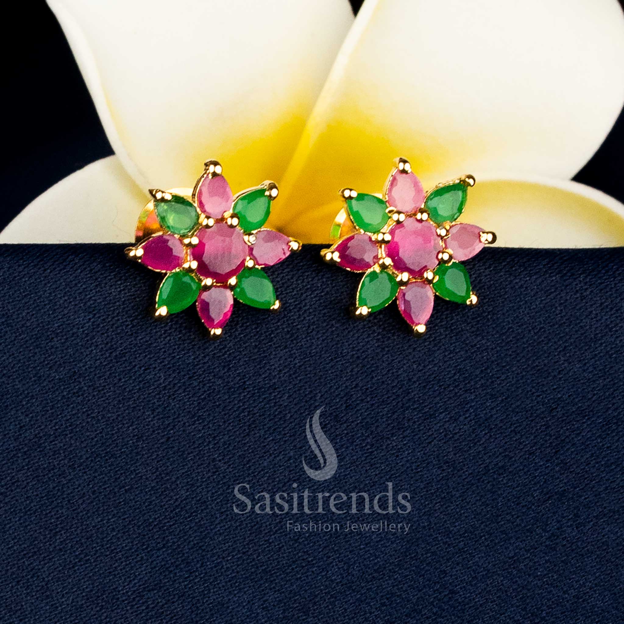 Gold plated teardrop floral earrings adorned with AD stones and pearl drops for special occasions Sasitrends