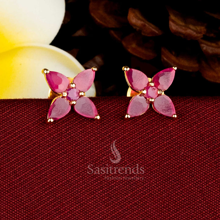 Sasitrends guaranteed finish 24K micro gold floral motif Ruby AD stones stud earrings, traditional gold look design ideal for temple and festive wear.