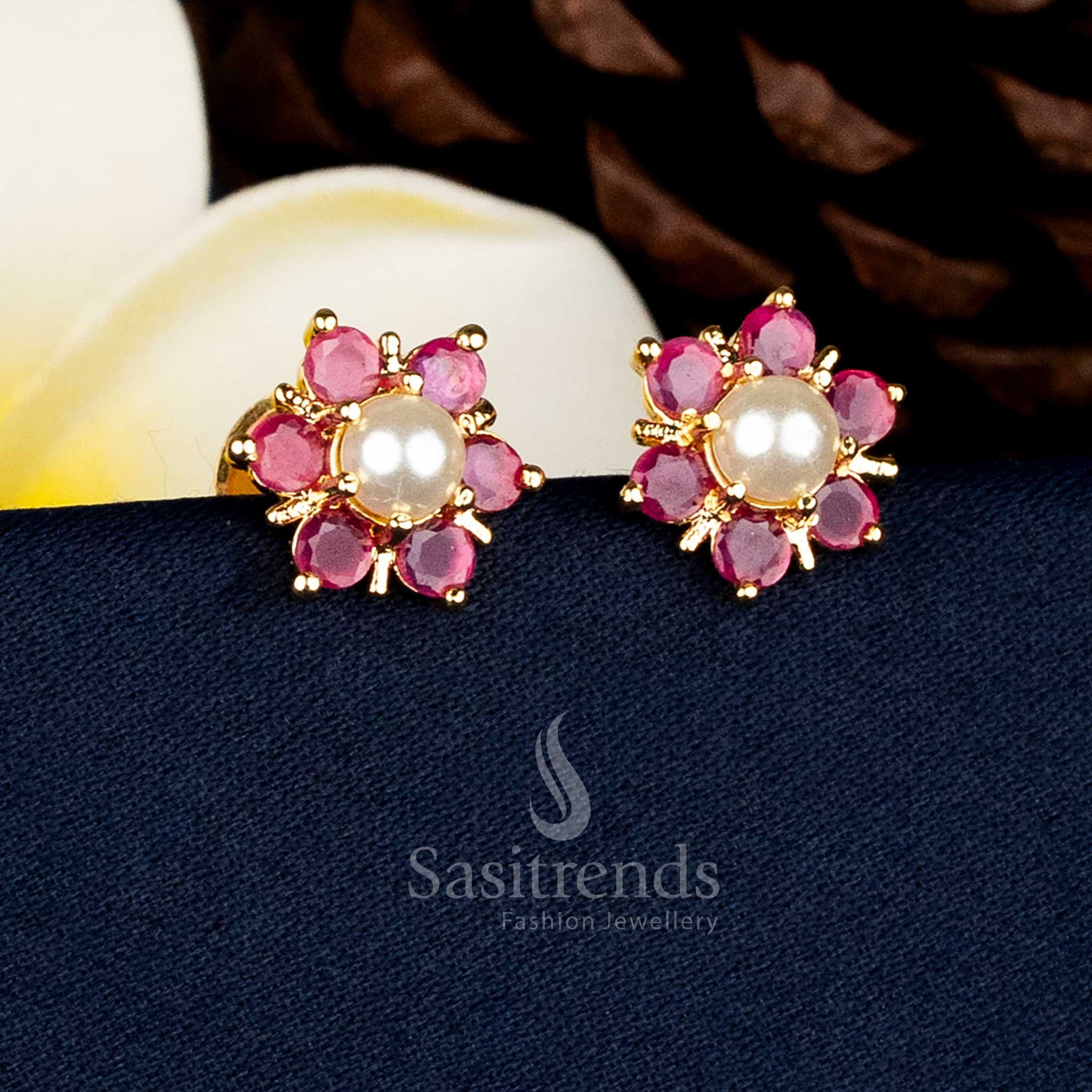 Guaranteed real gold look alike micro gold plated flower design stud earrings with pearl centre and intricate Ruby AD stone detailing for bridal and festive wear - Sasitrends
